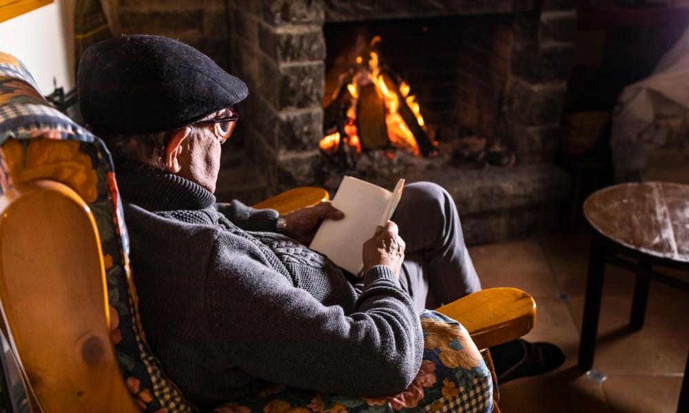 Older person in front of fire