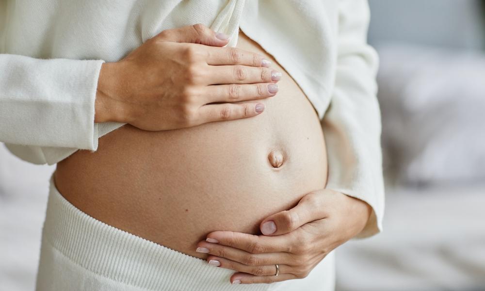 Pregnant woman showing bump