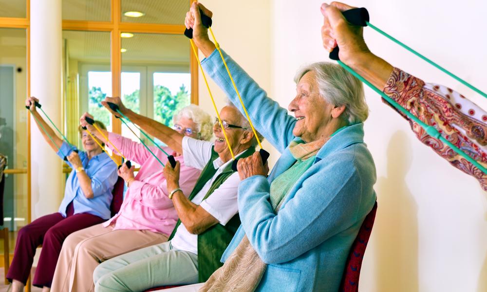 Older people exercising on chairs