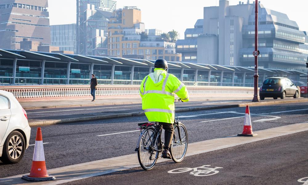 Cyclist in cycle lane with helmet and reflective clothing